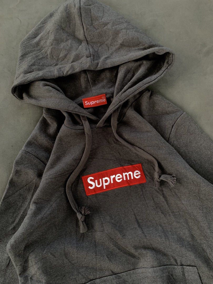 Supreme Grey Box Logo Hoodie (Category: Hoodies) located in Valencia. Submitted by davehandpicked (Listing ID 1458651469, Image 2). Description: - Classic Supreme hoodie - Grey colorway with iconic red box logo - Hood and drawstrings intact - Front pocket present - Great for everyday wear - Please check photos for detailed condition.