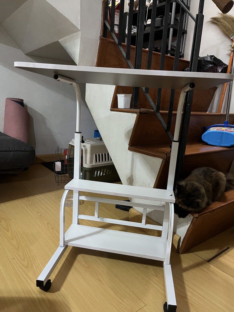 White Adjustable Laptop Table with Shelves on Wheels (Category: Tables & Sets) located in Manaoag. Submitted by thedaintyarts (Listing ID 1458581763, Image 3). Description: - Adjustable height white laptop table - Two shelves for convenient storage - Rolls on wheels for easy mobility - Ideal for working from home or studying - bought it from orange app Issue: - See 8th pic (nasobrahan sa pag pihit kaya tumagos yung screw) Loc: mandaluyong For pic