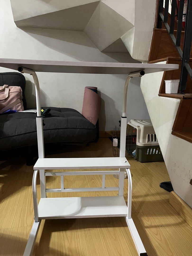 White Adjustable Laptop Table with Shelves on Wheels (Category: Tables & Sets) located in Manaoag. Submitted by thedaintyarts (Listing ID 1458581763, Image 2). Description: - Adjustable height white laptop table - Two shelves for convenient storage - Rolls on wheels for easy mobility - Ideal for working from home or studying - bought it from orange app Issue: - See 8th pic (nasobrahan sa pag pihit kaya tumagos yung screw) Loc: mandaluyong For pic
