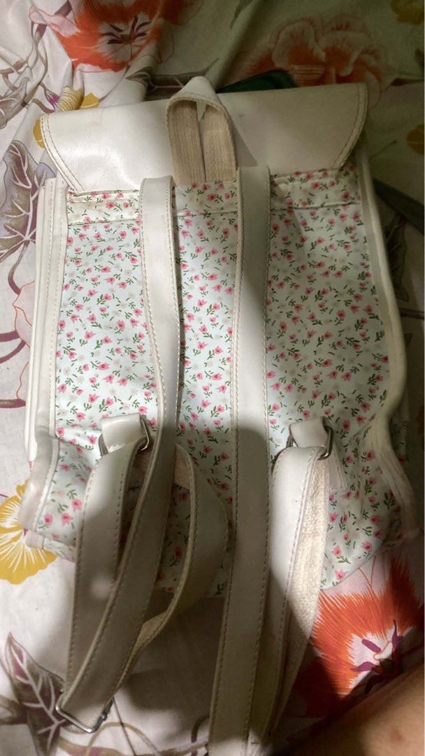 White Floral Backpack (Category: Backpacks) located in Manila. Submitted by annbrnld (Listing ID 1458614230, Image 2). Description: - Cute white backpack with a light blue floral print. - Two adjustable buckle straps on the front flap. - Interior pockets for organization. - Ideal for school or casual outings. - Shows some minor marks on the white flap..