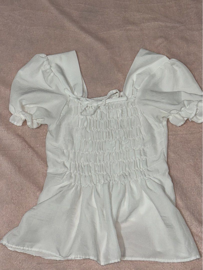 White Puff Sleeve Smocked Square Neck Top (Category: Blouses) located in Quezon City. Submitted by mjaasy (Listing ID 1458551308, Image 1). Description: - like new, worn only a few times - stretchable - no when worn pictures MOP: gcash/gotyme/maribank/bpi MOD: Lalamove/meetup (ust).