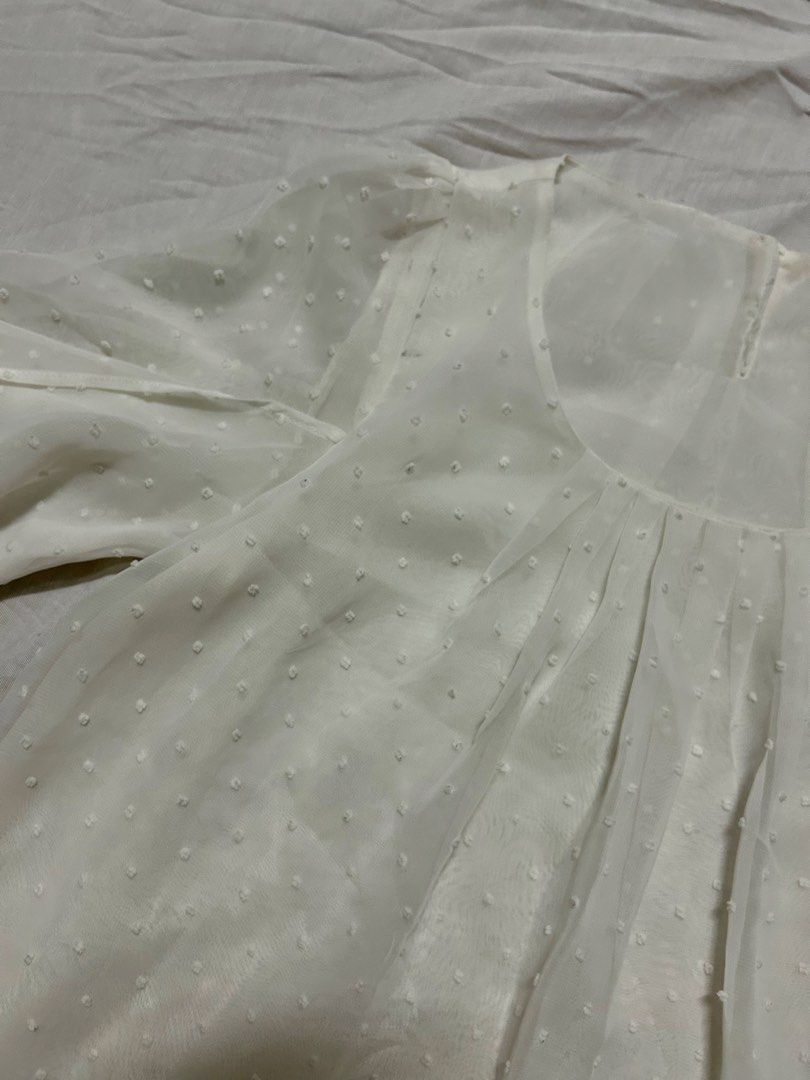 White sheer Swiss dot blouse (Category: Blouses) located in Quezon City. Submitted by rarefaithyyy (Listing ID 1458671472, Image 3). Description: - White sheer blouse - Features Swiss dot pattern - Size: Small (S) to Medium (M) - Condition: Excellent * thrifted expect minimal issues ‼️ reminders before purchasing ‼️ - no cancellation/return/refund of orders - mop: cash/gcash/banking - mod: meet-up/j&t/lalamove - meet up or shipping every Tuesdays