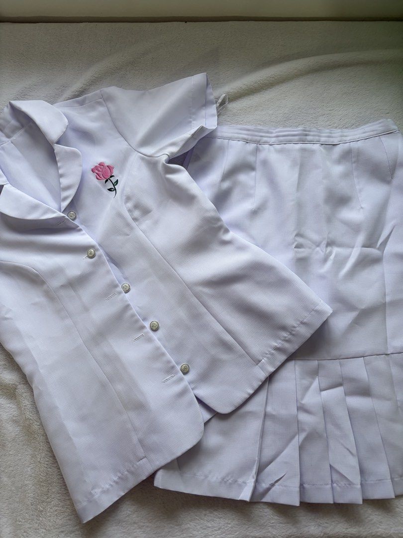 White Uniform Set with Rose Embroidery (Category: Sets or Coordinates) located in Antipolo. Submitted by trinannounce (Listing ID 1458599699, Image 2). Description: - White uniform set - Includes short-sleeved top with button closure - Features a pleated skirt - Adorned with a cute pink rose embroidery on the left chest - Ideal for nursing students and medical professionals - Offers a comfortable and professional look.
