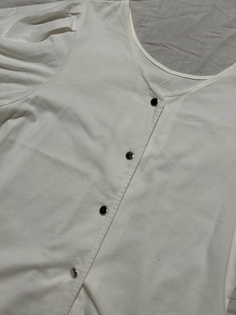 White V-Neck Short-Sleeve Blouse (Category: Blouses) located in Quezon City. Submitted by rarefaithyyy (Listing ID 1458672566, Image 2). Description: - White V-neck short-sleeve blouse - Size: S (EU 36/UK 8/US 4) - Features puff sleeves - Button-down front detail - Versatile and stylish * thrifted expect minimal issues ‼️ reminders before purchasing ‼️ - no cancellation/return/refund of orders - mop: cash/gcash/banking - mod: meet-up/j&t/lalamove
