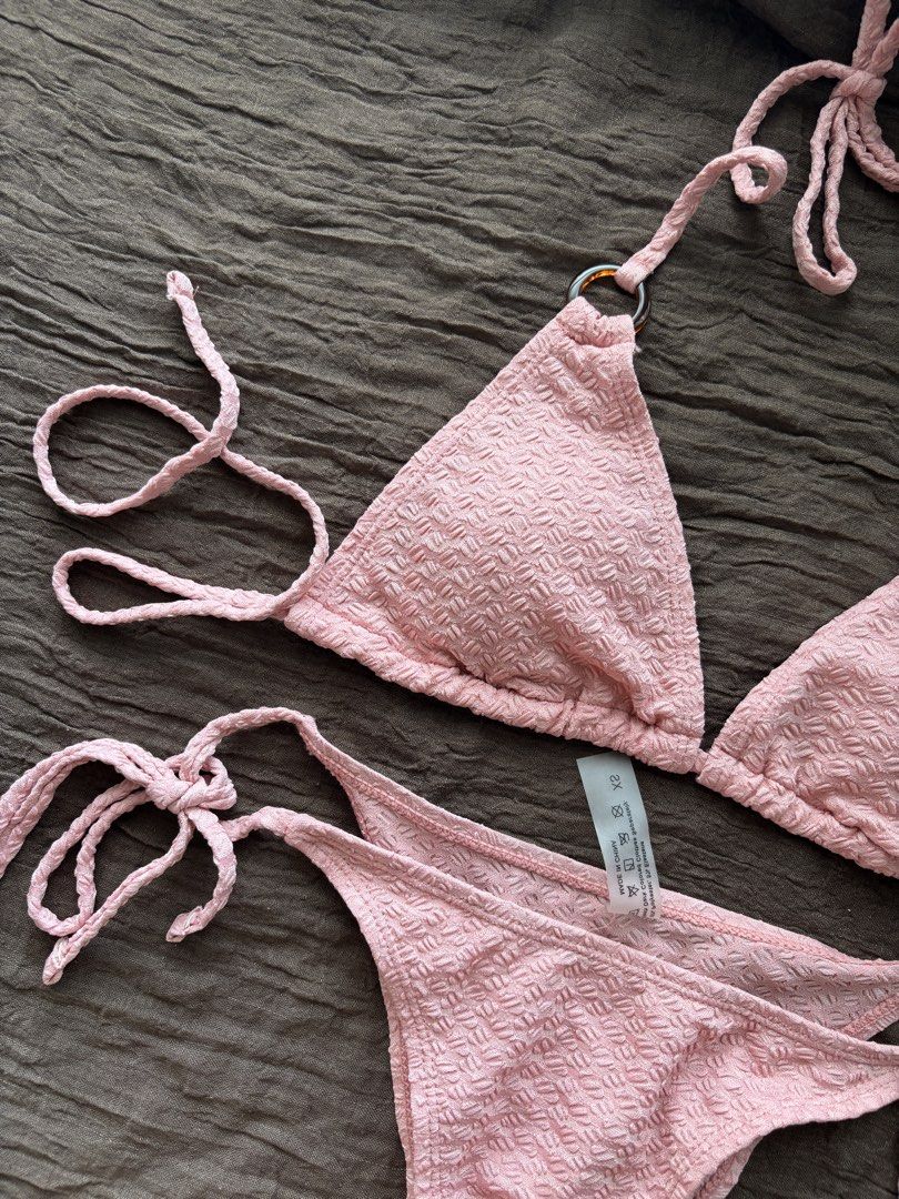 XS Pink Textured Triangle Bikini Set (Category: Bikinis & Swimsuits) located in Muntinlupa City. Submitted by jc444_ (Listing ID 1458677480, Image 2). Description: - Adorable pink bikini set - Textured fabric all over - Adjustable ties at neck and sides for a perfect fit - Chic ring details on bikini top straps - Tie-side bottoms for customizable comfort - Ideal for your next beach or pool day.