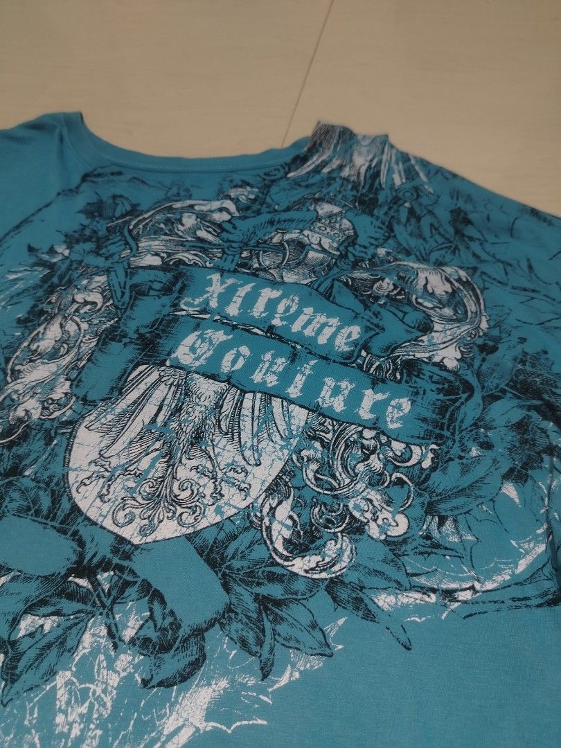 Xtreme Couture Y2K Grunge T-Shirt (Category: Tshirts & Polo Shirts ) located in Tanza. Submitted by reddererd (Listing ID 1458648853, Image 3). Description: Width: 25 Length: 27 Color Rate: 10 Condition: 10 Issues: altered length 📌This item is thrifted and/or personally used, so please manage your expectations Mode of Payment: G Cash Mode of Delivery: J&T.