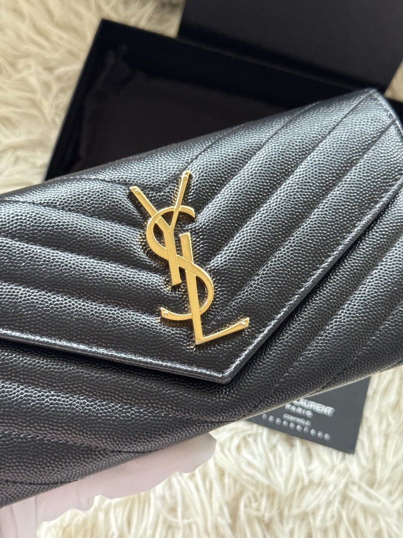YSL Long Wallet (Category: Luxury Bags & Wallets) located in Manila. Submitted by ccluxuryy (Listing ID 1458561808, Image 2). Description: Saint Laurent Cassandre Matelasse Large Flap Wallet Grained Leather Black GHW Very good condition with normal signs of usage Comes full box with cards P26k only ✨ Location: Merville, Paranaque Meet up: MOA, Newport, Greenbelt, BGC Delivery: Grab, Lalamove or LBC Guaranteed authentic or money back 💯.