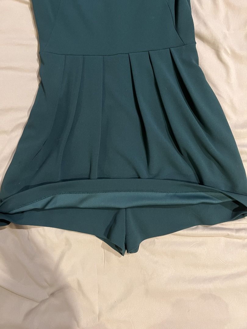 Zara Dark Green V-Neck Romper (Category: Rompers) located in Paranaque City. Submitted by cute.things.only (Listing ID 1458632982, Image 2). Description: - Zara dark green romper - V-neckline with button details down the back - Short puff sleeves - Pleated shorts section - Versatile for night out or casual day.