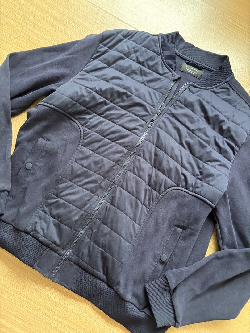 Zara Man Navy Blue Quilted Bomber Jacket (Category: Coats, Jackets and Outerwear) located in Makati City. Submitted by citysunset (Listing ID 1458570273, Image 2). Description: - Zara Man navy blue bomber jacket - Quilted front panel with zip closure - Ribbed collar, cuffs, and hem - Two side pockets with button closure - Ideal for layering - Size XXL.