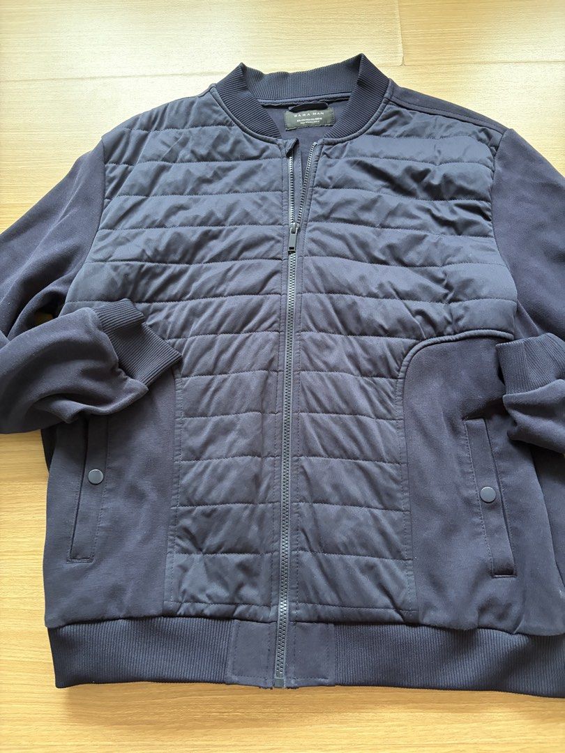 Zara Man Navy Blue Quilted Bomber Jacket (Category: Coats, Jackets and Outerwear) located in Makati City. Submitted by citysunset (Listing ID 1458570273, Image 3). Description: - Zara Man navy blue bomber jacket - Quilted front panel with zip closure - Ribbed collar, cuffs, and hem - Two side pockets with button closure - Ideal for layering - Size XXL.