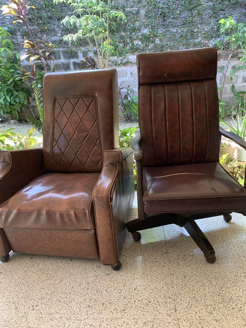 2 Brown Leather Office Chairs (Category: Chairs) located in Makati City. Submitted by chuasyc (Listing ID 1458786695, Image 1). Description: - Set of two classic brown leather chairs - One high-back swivel chair with wheels (ideal for office/study) - One traditional armchair - Both chairs have a timeless, classic look - Swivel chair has some visible wear and tear on the seat - Perfect for creating a stylish and comfortable office or study space.