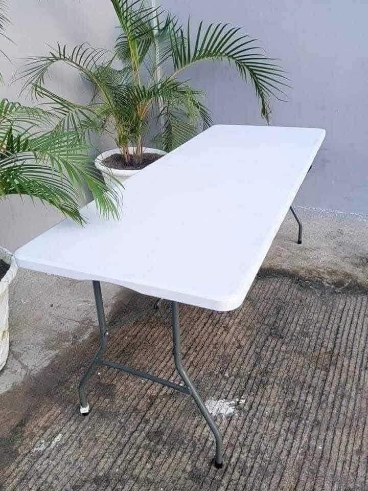 4ft Foldable Table - White Plastic Top, Metal Legs (Category: Tables & Sets) located in Manila. Submitted by tayson_earth (Listing ID 1458885951, Image 3). Description: - 4ft foldable table - White plastic top with sturdy metal legs - Folds flat for easy storage and transport - Ideal for events, parties, or extra workspace - Multiple units available - Approximately 4 feet long.