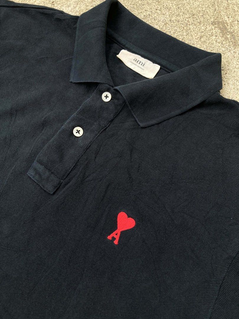 AMI BLACK POLO SHIRT (Category: Luxury Apparel) located in Dapitan. Submitted by thrift_archive2026 (Listing ID 1458736849, Image 2). Description: 📌 AMI Black Polo Shirt Red Heart ✅Authentic Featuring signature red embroidered Ami de Coeur logo on the chest Size Tag: XL Dimension Fit: Large Width: 22 Length: 28.5” Issue : Slight Fade Fold Line [Unnoticeable] 📍Mindanao, Zamboanga del norte, Dapitan City.