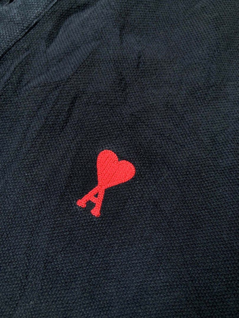 AMI BLACK POLO SHIRT (Category: Luxury Apparel) located in Dapitan. Submitted by thrift_archive2026 (Listing ID 1458736849, Image 3). Description: 📌 AMI Black Polo Shirt Red Heart ✅Authentic Featuring signature red embroidered Ami de Coeur logo on the chest Size Tag: XL Dimension Fit: Large Width: 22 Length: 28.5” Issue : Slight Fade Fold Line [Unnoticeable] 📍Mindanao, Zamboanga del norte, Dapitan City.