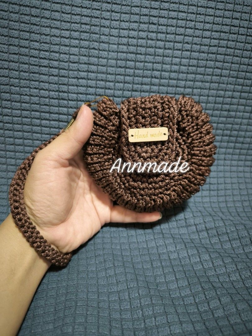 Annmade Handmade Crocheted Pouch Bag (Category: Purses & Pouches) located in Manila. Submitted by the.preloved.bags (Listing ID 1458743530, Image 2). Description: - Handmade crocheted pouch bag - Features a convenient wrist strap - Includes a charming 'Hand made' wooden tag - Ideal for storing small essentials (coins, keys, earbuds) - Available in four beautiful colors: green, brown, navy, and purple.