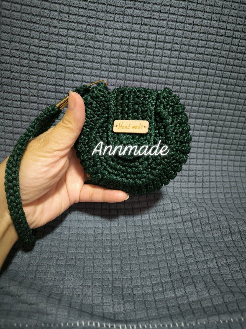 Annmade Handmade Crocheted Pouch Bag (Category: Purses & Pouches) located in Manila. Submitted by the.preloved.bags (Listing ID 1458743530, Image 1). Description: - Handmade crocheted pouch bag - Features a convenient wrist strap - Includes a charming 'Hand made' wooden tag - Ideal for storing small essentials (coins, keys, earbuds) - Available in four beautiful colors: green, brown, navy, and purple.