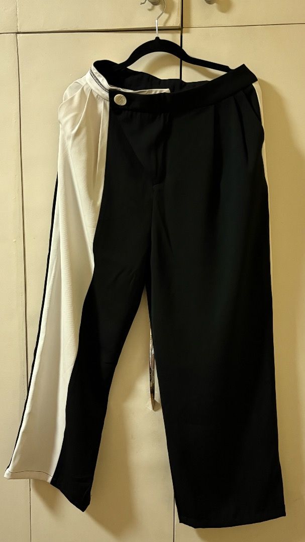 Asymmetrical Black and White Wide Leg Pants (Category: Other Bottoms) located in Taguig. Submitted by fayneayana (Listing ID 1458820116, Image 1). Description: - Cool asymmetrical design: one black leg, one white leg with a black stripe. - Trendy wide-leg cut. - Flattering high-waisted fit. - Secure button closure. - A unique statement piece to elevate your wardrobe..