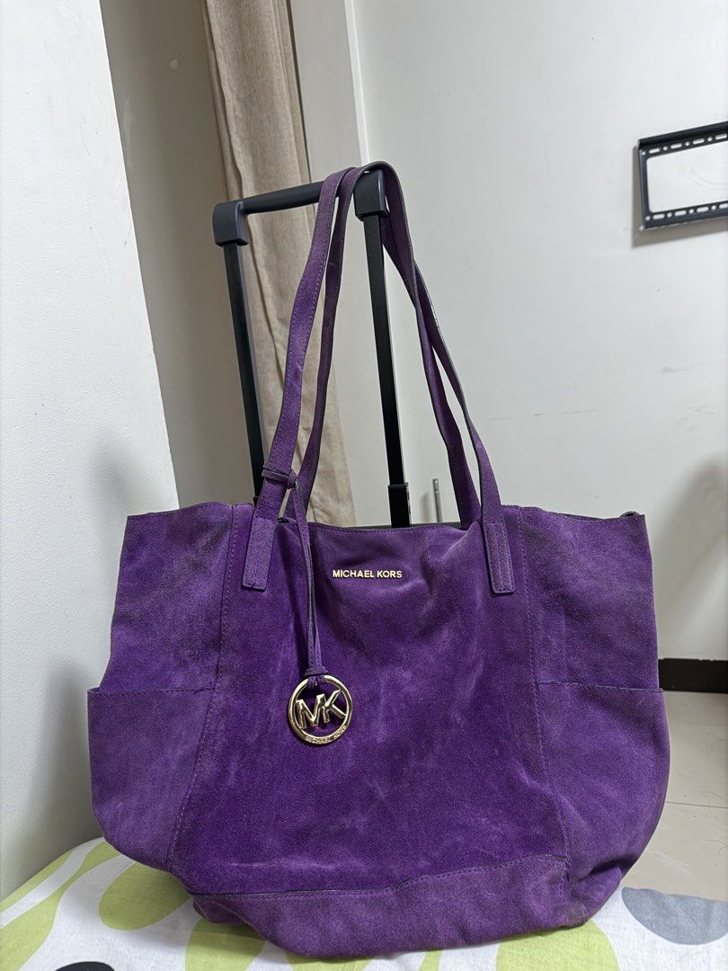 Authentic Michael Kors Purple Suede Tote Bag (Category: Luxury Bags & Wallets) located in Manila. Submitted by warmcat.b45a52 (Listing ID 1458842136, Image 1). Description: - Authentic Michael Kors purple suede tote bag - Large size, ideal for everyday essentials - Adorned with the signature MK logo charm - A stylish and practical addition to your collection - Issue shown on last slide: discoloration on edges.
