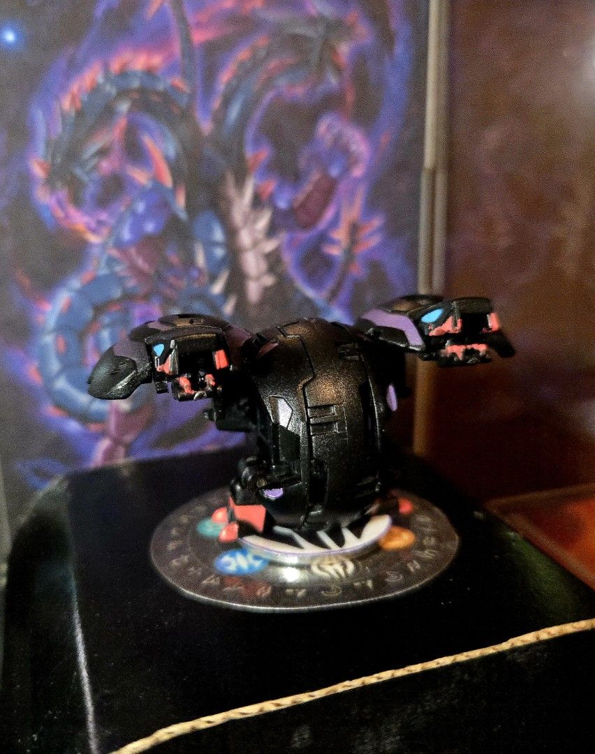 B2 Darkus Dual Headed Hydranoid Bakugan (Category: Action & Battle Toys) located in Calasiao. Submitted by silo2191 (Listing ID 1458858322, Image 2). Description: Character: Dual Hydranoid (Dual Hydra) Attribute: Darkus (Shadow / Black) Series: Original Series / Generation 1 (B2 Size) Manufacturer: Spin Master / Sega Toys Condition: Pre-owned vintage condition. The pop-open transformation mechanism triggers cleanly on a magnetic surface, and the 