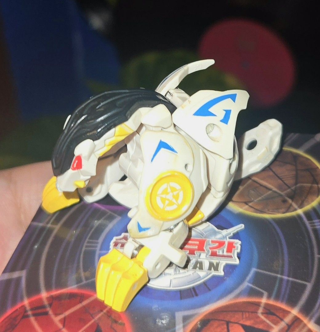 Bakugan- Bakutech Haos Well Gallow (Missing Tail) (Category: Action & Battle Toys) located in Calasiao. Submitted by silo2191 (Listing ID 1458871134, Image 1). Description: Character: Well Galow Attribute: Haos (White/Yellow/Black) Manufacturer: Sega Toys (Japan exclusive) Condition & Function: The tip of the tail piece is missing, but it still closes tightly into a perfect ball form. Mechanism Note: The latch is a bit stiff and does not automati