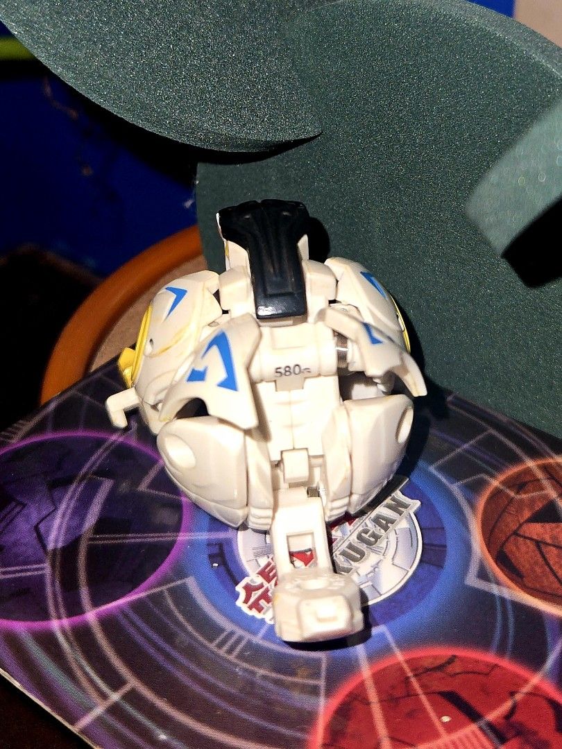 Bakugan- Bakutech Haos Well Gallow (Missing Tail) (Category: Action & Battle Toys) located in Calasiao. Submitted by silo2191 (Listing ID 1458871134, Image 3). Description: Character: Well Galow Attribute: Haos (White/Yellow/Black) Manufacturer: Sega Toys (Japan exclusive) Condition & Function: The tip of the tail piece is missing, but it still closes tightly into a perfect ball form. Mechanism Note: The latch is a bit stiff and does not automati