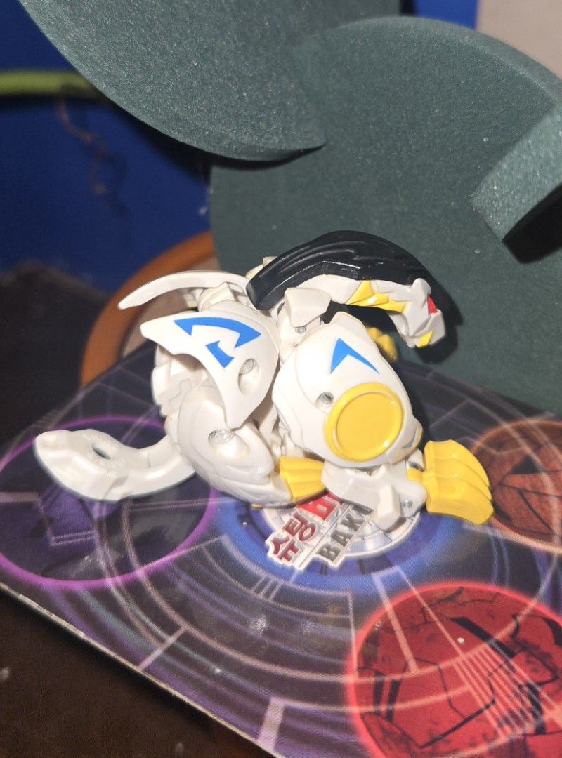 Bakugan- Bakutech Haos Well Gallow (Missing Tail) (Category: Action & Battle Toys) located in Calasiao. Submitted by silo2191 (Listing ID 1458871134, Image 2). Description: Character: Well Galow Attribute: Haos (White/Yellow/Black) Manufacturer: Sega Toys (Japan exclusive) Condition & Function: The tip of the tail piece is missing, but it still closes tightly into a perfect ball form. Mechanism Note: The latch is a bit stiff and does not automati