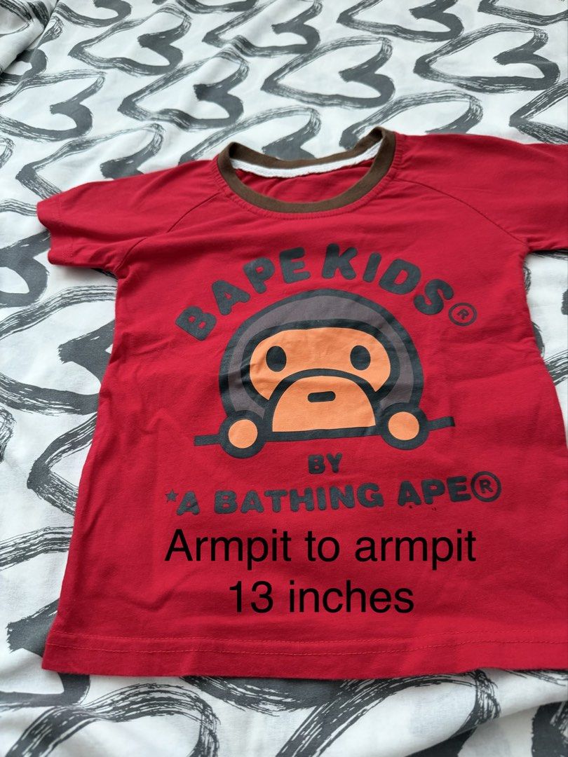 BAPE Kids Shirt (Category: Babies & Kids Fashion) located in Pasig City. Submitted by fancytracy (Listing ID 1458706716, Image 1). Description: Flaw: Stain (right upper part),2 small holes. Refer to photo Disclaimer Can’t guarantee the authenticity since these are hand me downs.