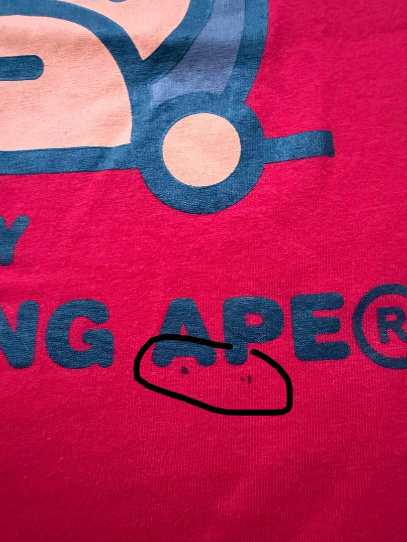 BAPE Kids Shirt (Category: Babies & Kids Fashion) located in Pasig City. Submitted by fancytracy (Listing ID 1458706716, Image 2). Description: Flaw: Stain (right upper part),2 small holes. Refer to photo Disclaimer Can’t guarantee the authenticity since these are hand me downs.