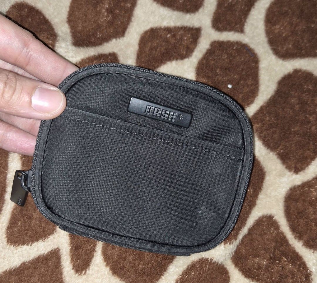 BASH Black Coin Pouch with Zipper and Detachable Strap (Category: Purses & Pouches) located in Pasig City. Submitted by bash0011 (Listing ID 1458781156, Image 1). Description: - Brand: BASH - Color: Black - Main compartment with zipper - Inner pocket - Front slip pocket - Detachable ring for easy carrying - Ideal for coins, cards, and small essentials.
