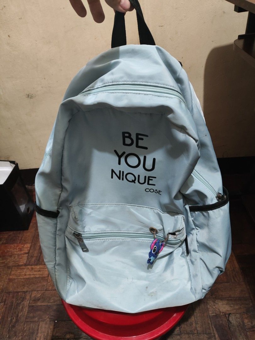 BE YOU NIQUE Light Blue Backpack with Stitch Keychain (Category: Shoulder Bags) located in Manila. Submitted by warmshark.1ae1ea (Listing ID 1458778702, Image 2). Description: ✨ Cute light blue backpack ✨ Spacious and lightweight design ✨ With side pockets and front compartment ✨ Includes Stitch keychain Condition: Used condition Some stains due to usage Back zipper is damaged/not working, but bag is still usable RFS: Not using anymore.