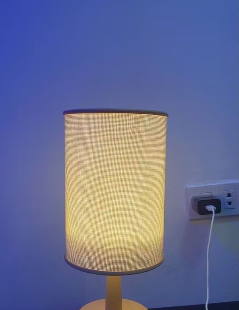 Beige Fabric Drum Table Lamp with Wooden Base (Category: Lighting) located in Quezon City. Submitted by Solanawear (Listing ID 1458750694, Image 2). Description: - Cute bedside lamp with textured beige fabric shade. - Light wood colored base. - Wall plug-in for convenient use. - Emits a warm, cozy light. - Ideal for nightstands, desks, or adding ambiance to any room..