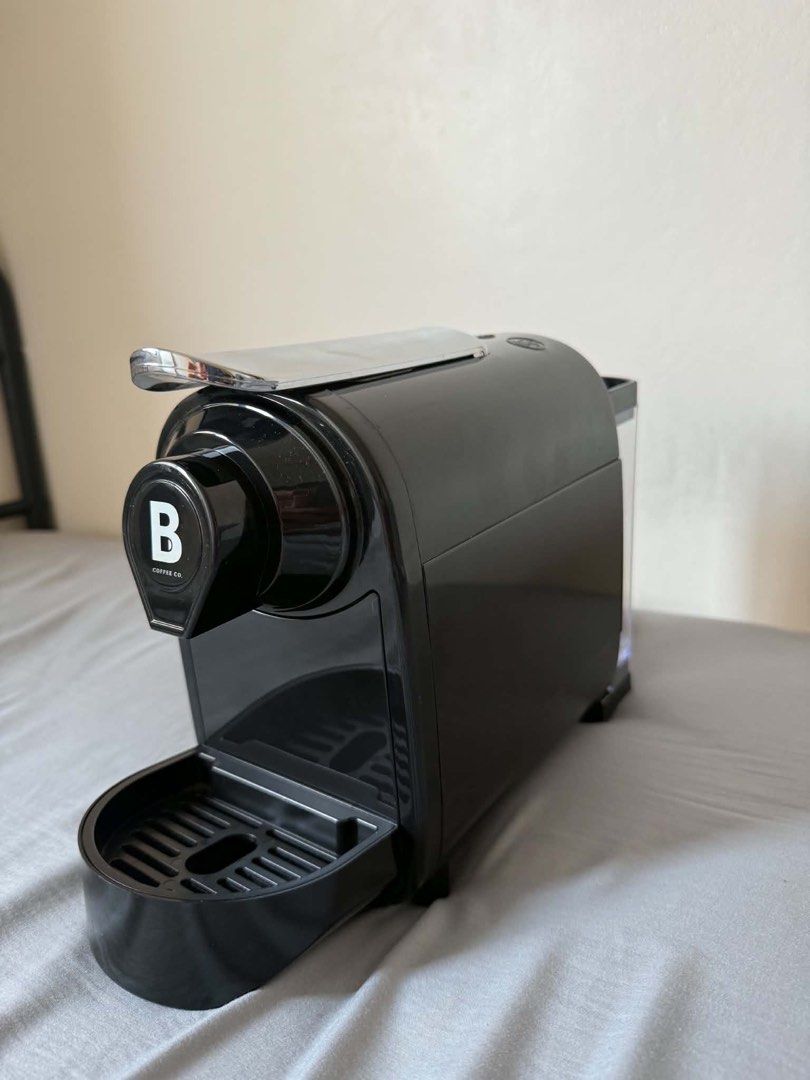 Black B Coffee Co. Capsule Coffee Machine (Category: Coffee Machines & Makers) located in Dasmarinas. Submitted by catgo (Listing ID 1458886328, Image 3). Description: - B Coffee Co. black capsule coffee machine - Compact and easy to use - Perfect for your daily coffee fix - Drip tray included - Power cord and plug shown - Ready for a new home.