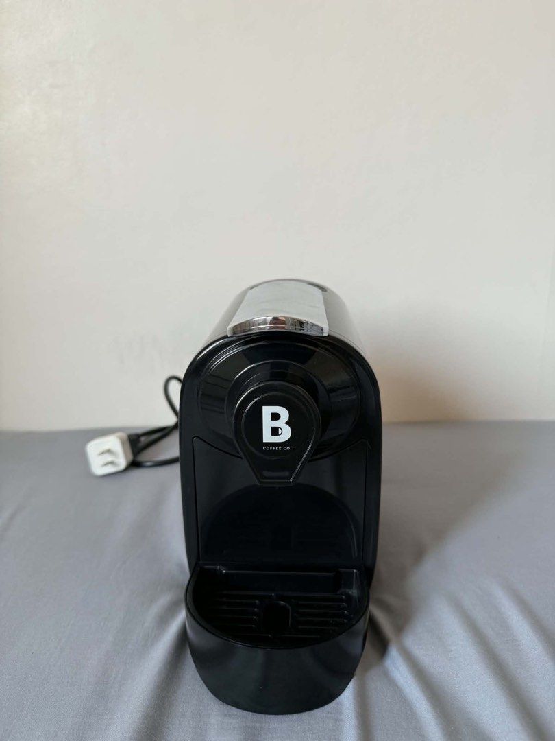 Black B Coffee Co. Capsule Coffee Machine (Category: Coffee Machines & Makers) located in Dasmarinas. Submitted by catgo (Listing ID 1458886328, Image 2). Description: - B Coffee Co. black capsule coffee machine - Compact and easy to use - Perfect for your daily coffee fix - Drip tray included - Power cord and plug shown - Ready for a new home.