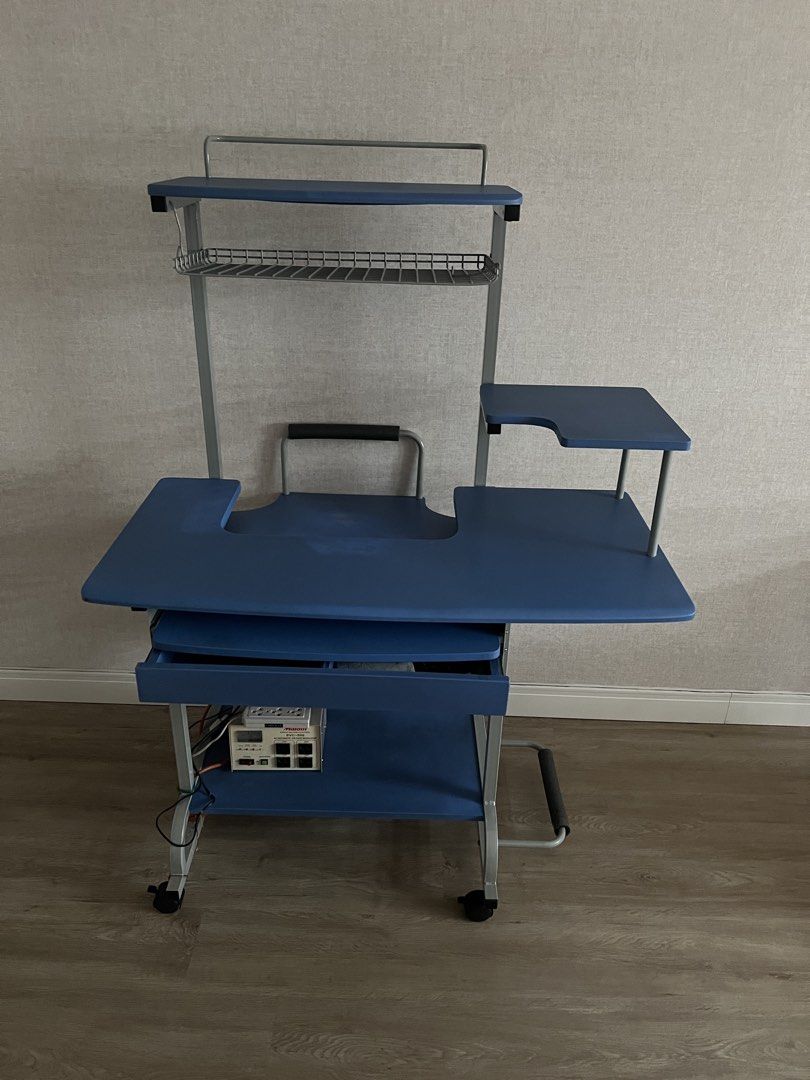 Blue Rolling Computer Desk with Shelves and Keyboard Tray (Category: Tables & Sets) located in Manila. Submitted by lorymingui15824 (Listing ID 1458774522, Image 3). Description: - Blue rolling computer desk - Pull-out keyboard tray - Multiple shelves for storage - Top shelf with wire rack - On wheels for easy movement - Ideal for small workspaces or dorm rooms - Minor scuffs on frame from use.
