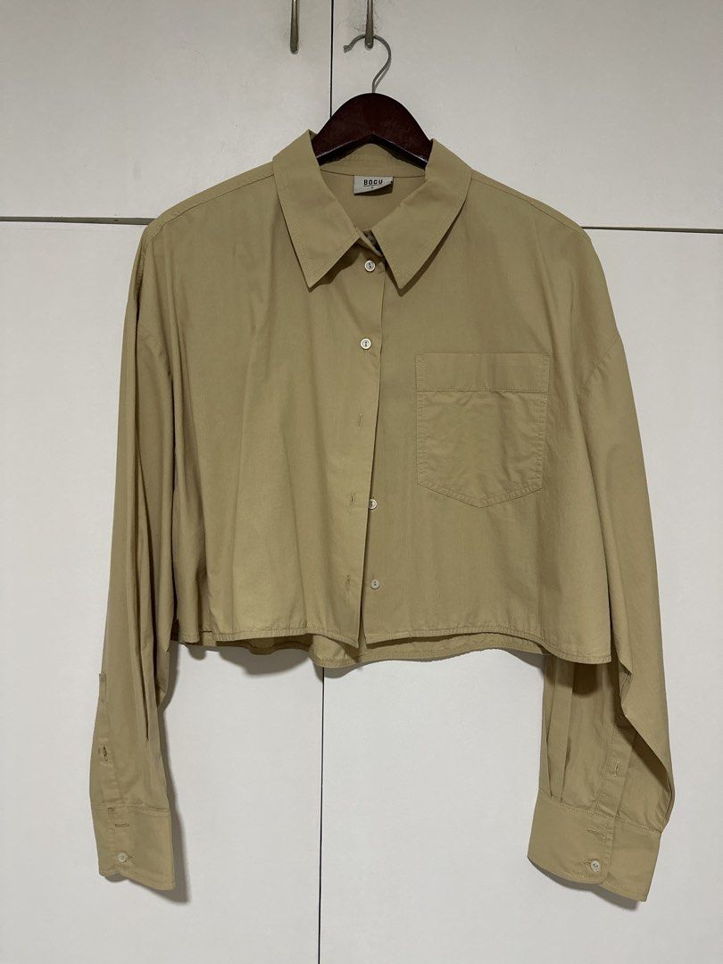 BOCU Cropped Button-Up Shirt - Khaki (Category: Shirts) located in Pasig City. Submitted by tinqsalazar (Listing ID 1458814229, Image 1). Description: - Brand: BOCU (used once or twice only) - Color: Khaki - Style: Cropped button-up shirt - Features: Long sleeves with button cuffs, single chest pocket - Great for layering or wearing on its own, pairs well with high-waisted bottoms.