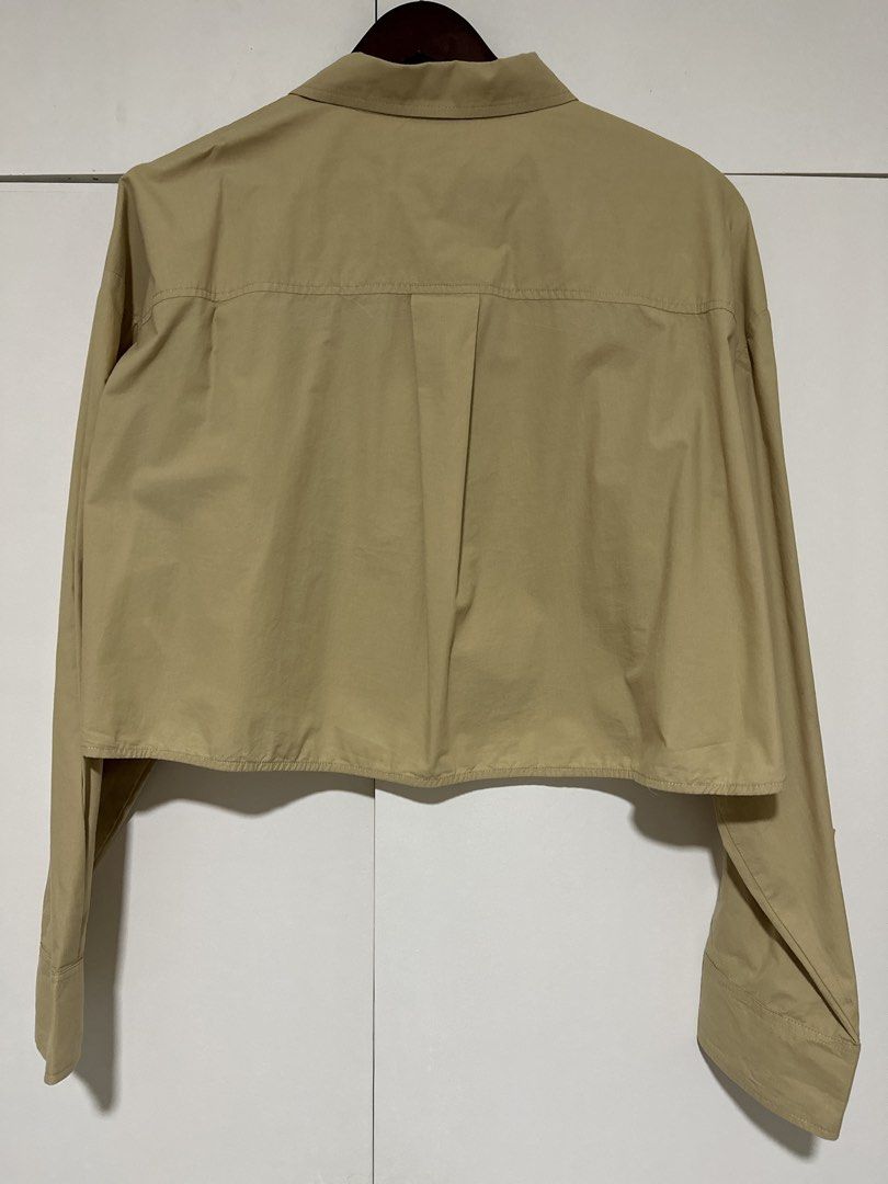 BOCU Cropped Button-Up Shirt - Khaki (Category: Shirts) located in Pasig City. Submitted by tinqsalazar (Listing ID 1458814229, Image 3). Description: - Brand: BOCU (used once or twice only) - Color: Khaki - Style: Cropped button-up shirt - Features: Long sleeves with button cuffs, single chest pocket - Great for layering or wearing on its own, pairs well with high-waisted bottoms.