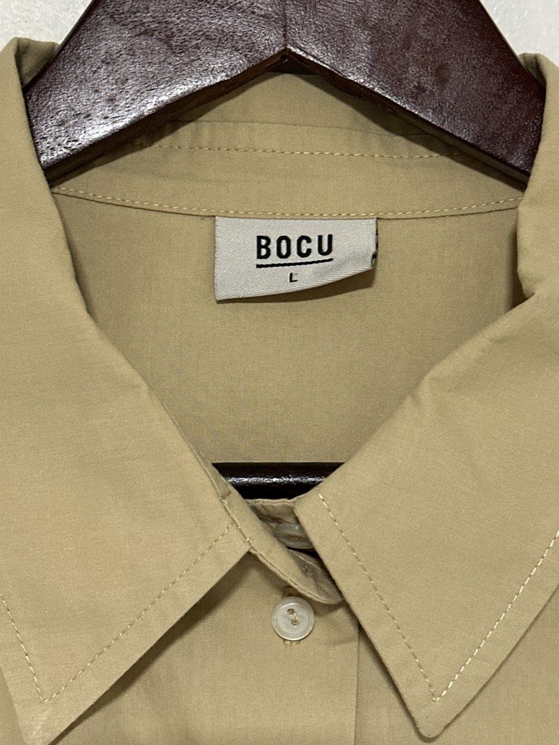 BOCU Cropped Button-Up Shirt - Khaki (Category: Shirts) located in Pasig City. Submitted by tinqsalazar (Listing ID 1458814229, Image 2). Description: - Brand: BOCU (used once or twice only) - Color: Khaki - Style: Cropped button-up shirt - Features: Long sleeves with button cuffs, single chest pocket - Great for layering or wearing on its own, pairs well with high-waisted bottoms.