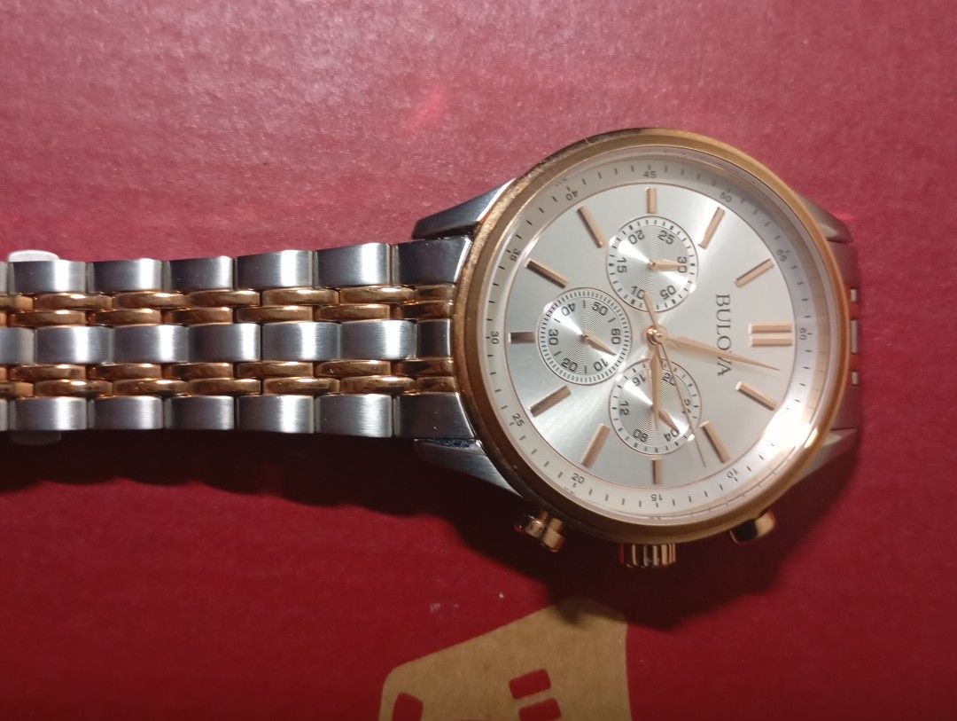 Bulova Chronograph Watch Two-Tone Stainless Steel (Category: Luxury Watches) located in Lapu Lapu. Submitted by rararockce65981 (Listing ID 1458864421, Image 2). Description: - Brand: Bulova - Style: Chronograph Watch - Band: Two-tone stainless steel with gold accents - Dial: Silver with sub-dials - Features: Water resistant - Movement: Japan Movement - Band Origin: China - Model Number: 98A216 - Serial Number: 23086970 - Case Number: C4691973 - 