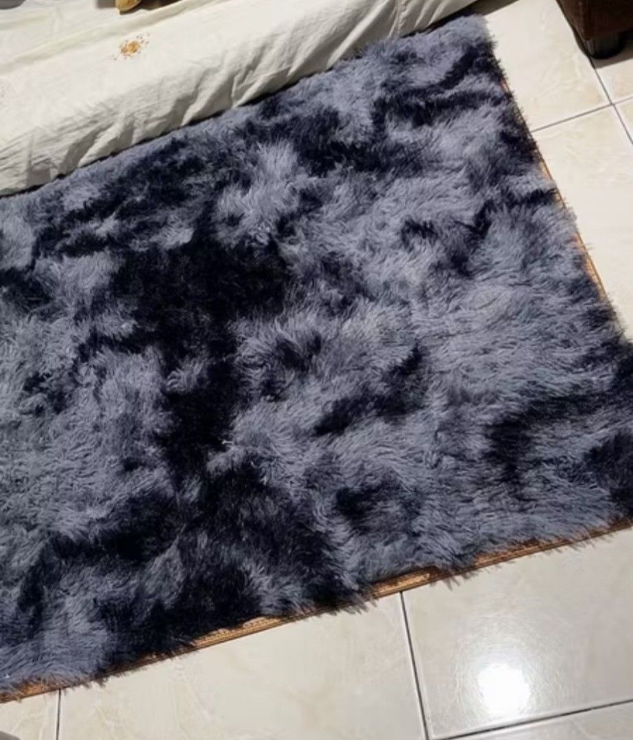Carpet - Dark Grey Tie-Dye Fluffy Rug (Category: Carpets, Mats & Flooring) located in Quezon City. Submitted by ladytaurus87416 (Listing ID 1458728408, Image 2). Description: - Super soft and fluffy texture - Stylish dark grey tie-dye pattern - Generous size: 200x200cm - Ideal for living rooms or bedrooms - Creates a cozy and inviting atmosphere - Easy to maintain and clean.
