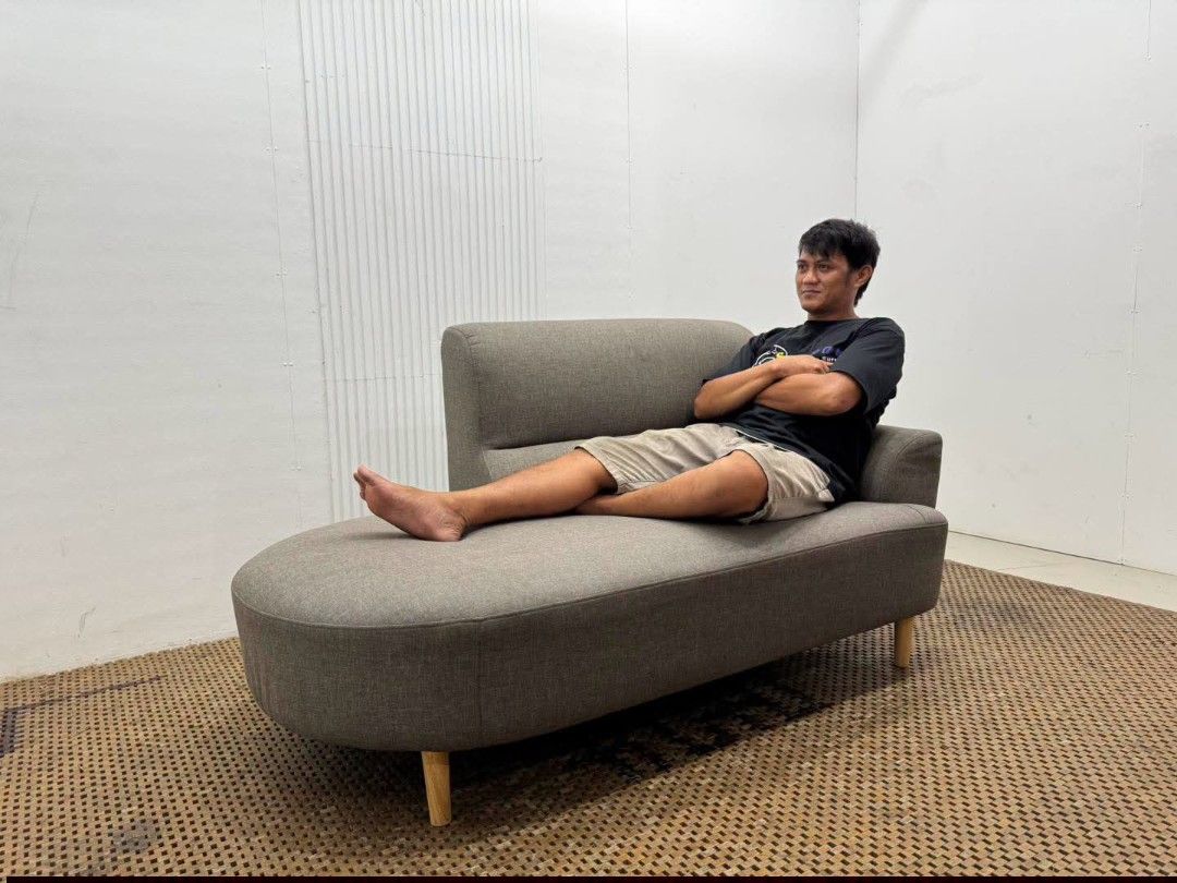 Chaise Lounged Sofa (Category: Sofas) located in Meycauayan. Submitted by marygracecasimiro (Listing ID 1458845397, Image 3). Description: Modern Curved Single-Arm Chaise Lounge Sofa Price: 13,900 L64 x W31.5 x H33/16 In good condition♥️ It has a wide lounging seat, one side armrest, integrated backrest, and tapered wooden legs, giving it a clean modern/Mid-Century look..