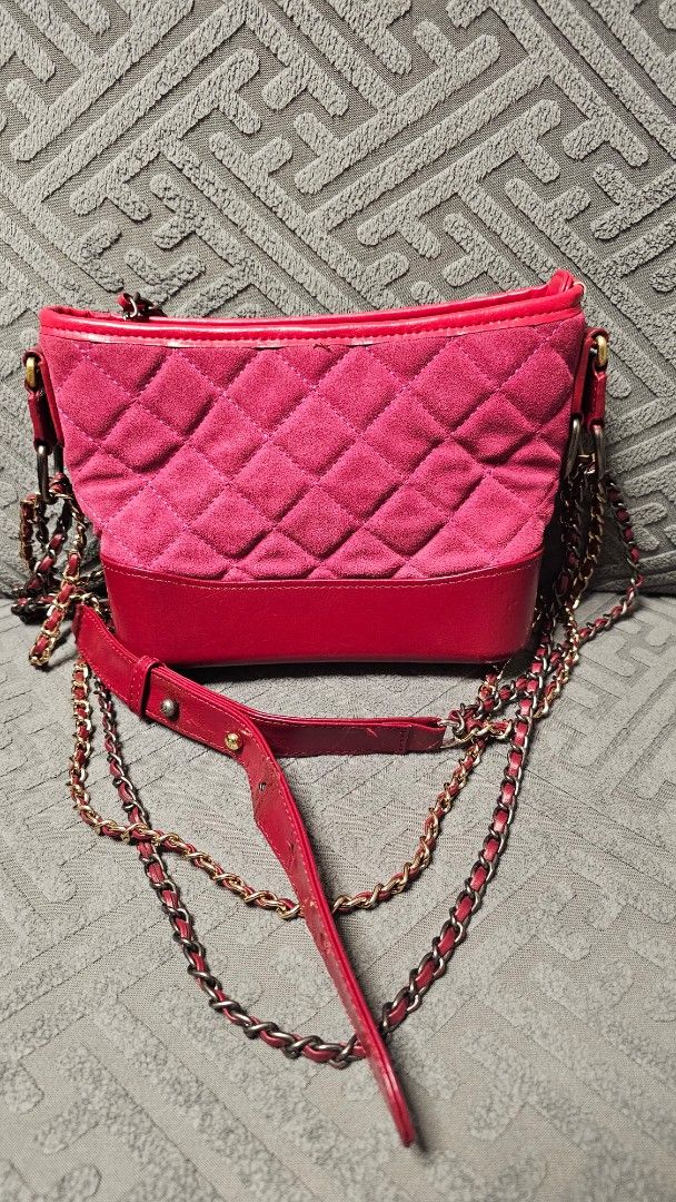 Channele Pink Suede & Red Leather Chain Bag (Category: Luxury Bags & Wallets) located in Quezon City. Submitted by jollythrift (Listing ID 1458837610, Image 3). Description: - Pink quilted suede exterior - Red leather trim accents - Gold and dark gray chain strap - Multiple interior compartments for organization - Minor signs of wear on leather strap and edges - Zipper functions smoothly - Classic and stylish piece.