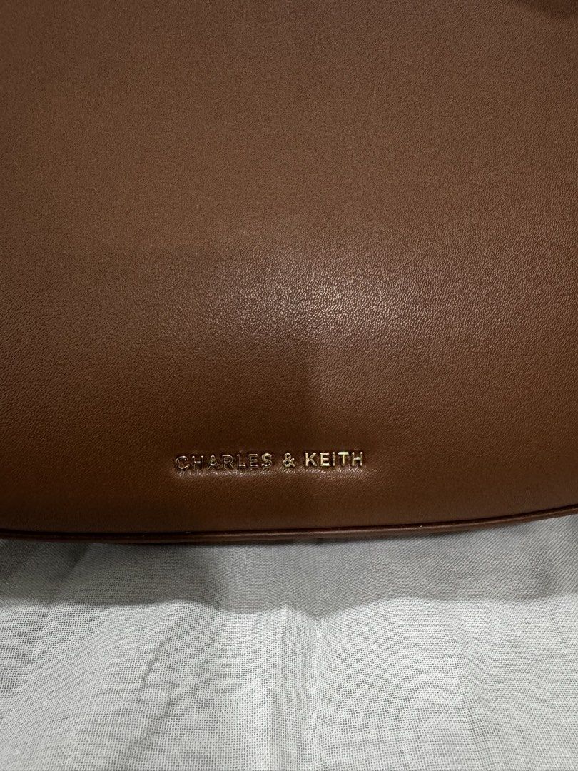 Charles & Keith Brown Crescent Shoulder Bag (Category: Shoulder Bags) located in Pasig City. Submitted by funnelboy (Listing ID 1458829599, Image 2). Description: - Brand: Charles & Keith - Color: Brown - Style: Shoulder Bag - Shape: Classic Crescent - Hardware: Gold detail - Condition: Great for everyday use - Includes: Dust bag.