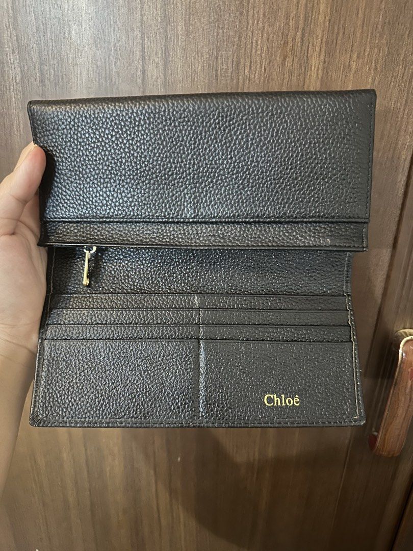 Chloe Black Leather Long Wallet (Category: Luxury Bags & Wallets) located in Batangas. Submitted by jhinp0t (Listing ID 1458772932, Image 3). Description: - Genuine Leather Chloe black pebbled leather long wallet -Ykk zipper - Elegant gold-tone clasp closure with decorative stones - Multiple interior card slots for easy organization - Secure zippered compartment for coins or receipts - Subtle embossed Chloe logo inside.
