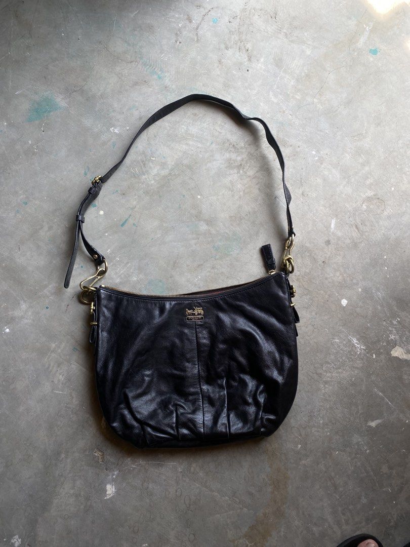 Coach Black Leather Hobo Shoulder Bag (Category: Luxury Bags & Wallets) located in Lucena. Submitted by handpickthrift (Listing ID 1458733627, Image 1). Description: - Genuine black leather Coach hobo bag - Soft, slouchy silhouette - Elegant gold hardware with iconic Coach horse and carriage logo - Striking red interior lining - Adjustable shoulder strap for customized fit - Ideal everyday bag with generous interior space.