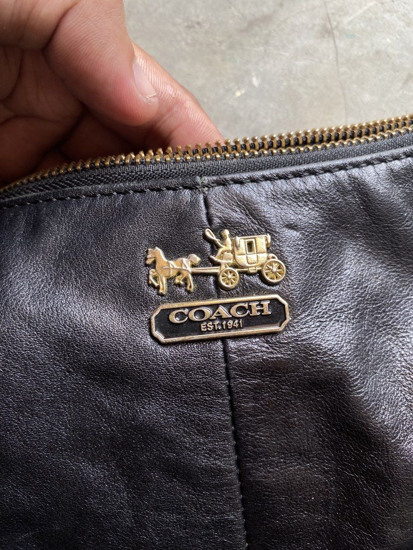 Coach Black Leather Hobo Shoulder Bag (Category: Luxury Bags & Wallets) located in Lucena. Submitted by handpickthrift (Listing ID 1458733627, Image 3). Description: - Genuine black leather Coach hobo bag - Soft, slouchy silhouette - Elegant gold hardware with iconic Coach horse and carriage logo - Striking red interior lining - Adjustable shoulder strap for customized fit - Ideal everyday bag with generous interior space.