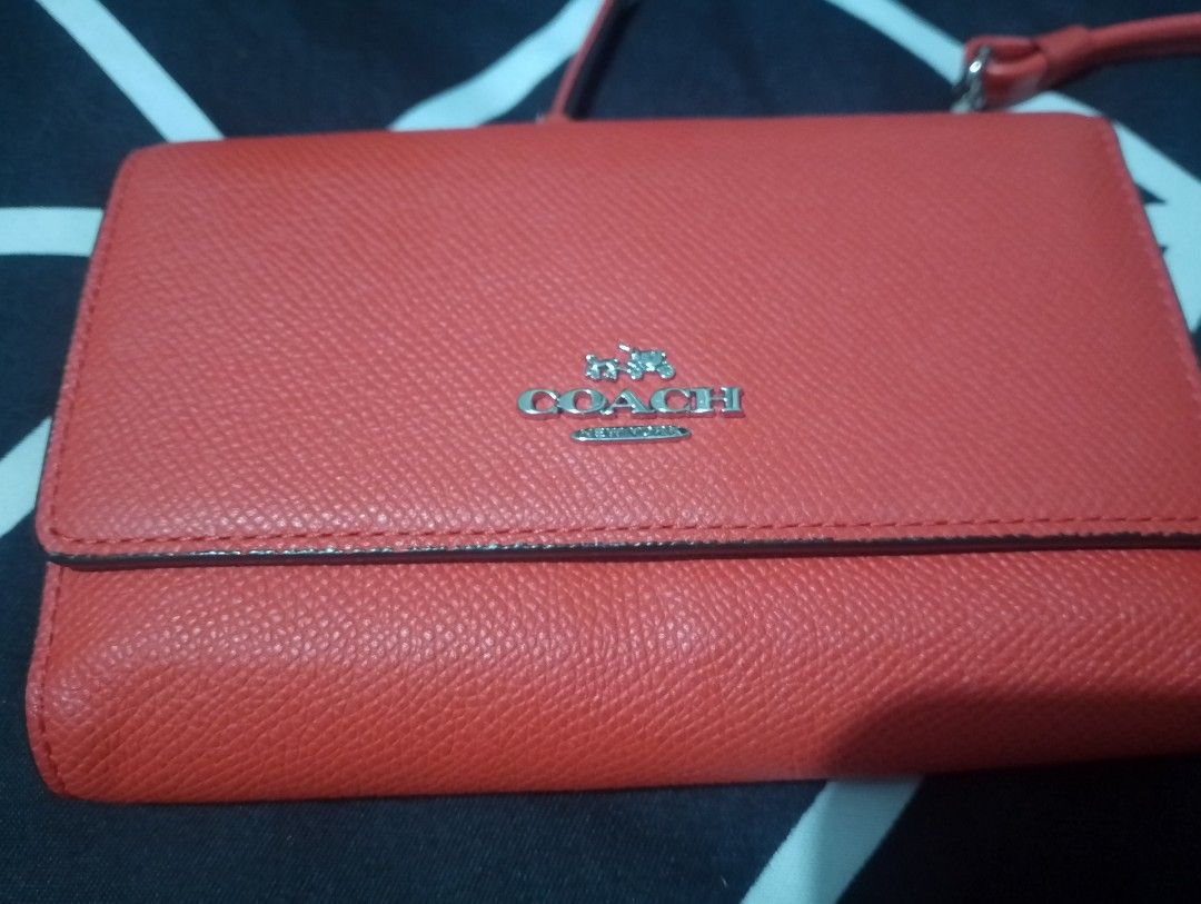 Coach Orange Leather Wallet on Chain Bag (Category: Luxury Bags & Wallets) located in Manila. Submitted by heart.09 (Listing ID 1458887512, Image 1). Description: -slight negotiable Orange leather Coach wallet on chain. Has multiple card slots inside and a zippered compartment. The strap is detachable. Perfect for carrying essentials..