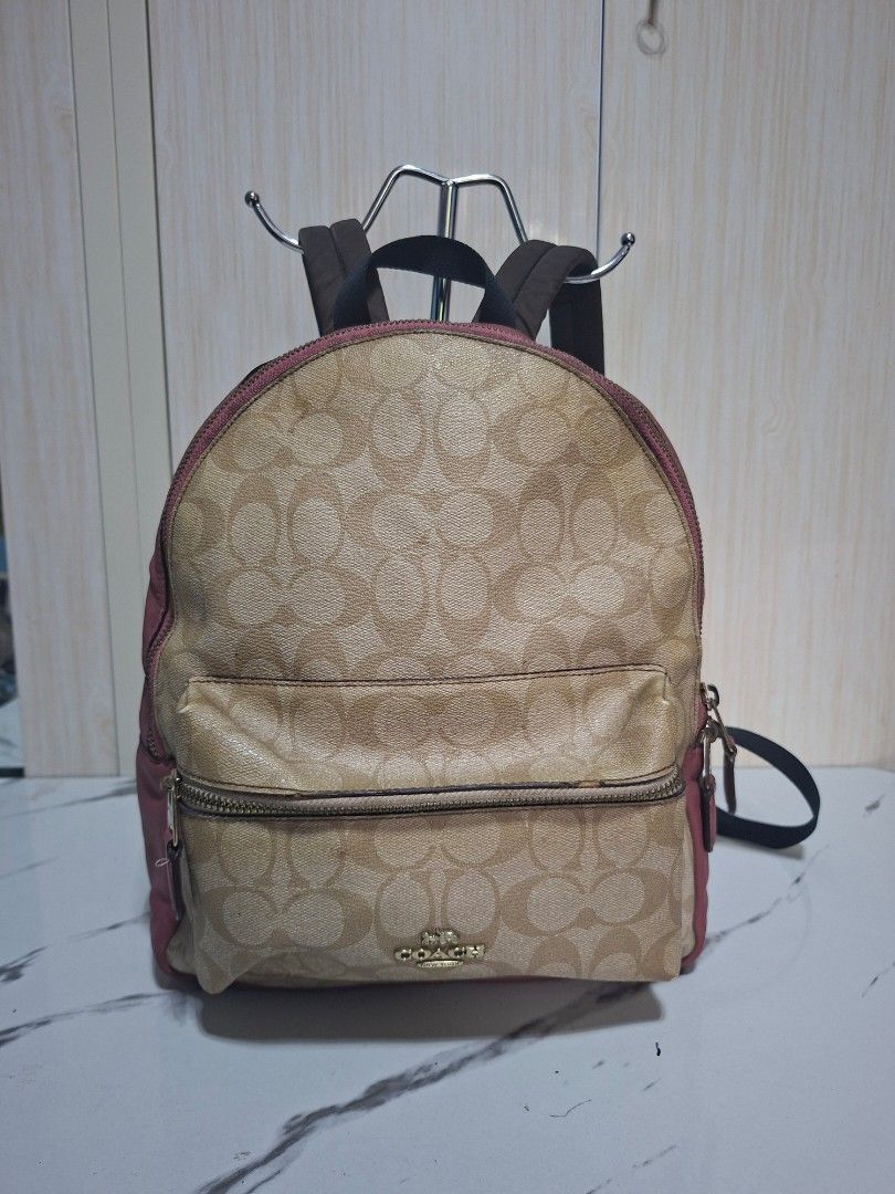 Coach Signature Canvas & Leather Backpack Pink (Category: Backpacks) located in Guimba. Submitted by imerlouberlykym (Listing ID 1458773457, Image 1). Description: - Authentic Coach backpack - Signature canvas with pink leather accents - Front zip pocket for easy access - Spacious main compartment - Adjustable straps for a comfortable fit - Proudly made in the Philippines - Shows some signs of wear (interior & exterior), please refer to pictures.