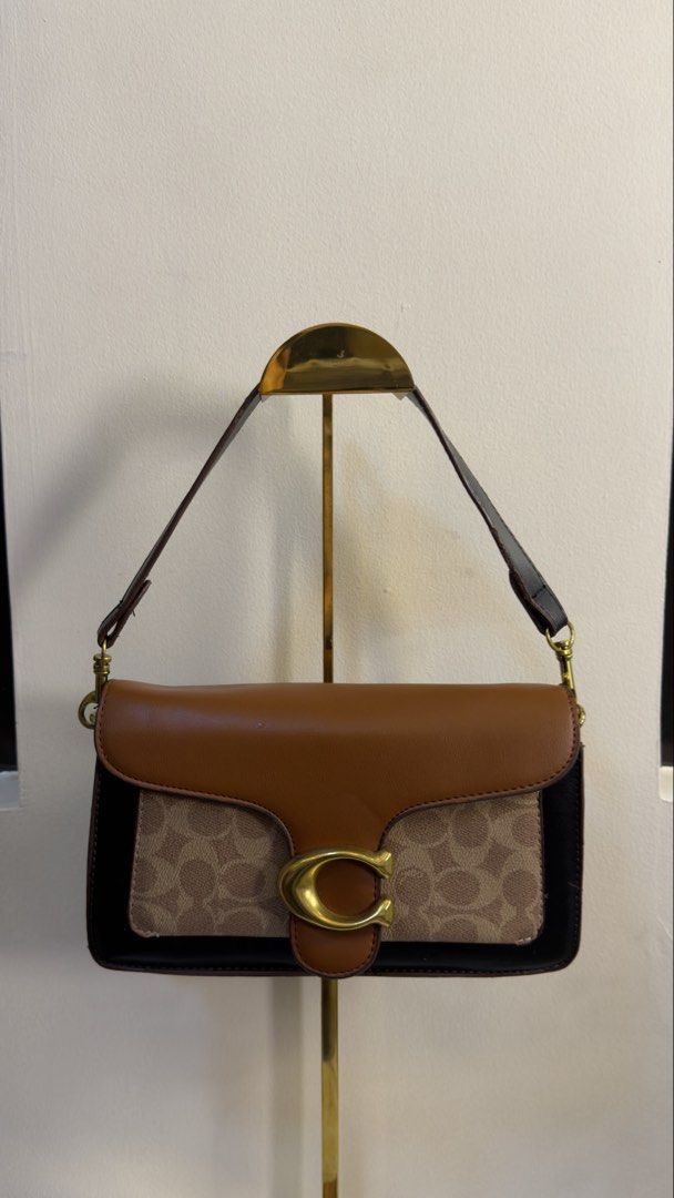 Coach Tabby shoulder and crossbody bag (Category: Cross-body Bags) located in Paranaque City. Submitted by preluxeshop_ph (Listing ID 1458792038, Image 2). Description: Coach Tabby shoulder and crossbody bag black and brown canvas texture Leather shoulder strap gold-tone hardware logo plaque foldover top magnetic fastening internal zip-fastening pocket Condition: GOOD. This previously owned and used item is in good condition with minimal signs of