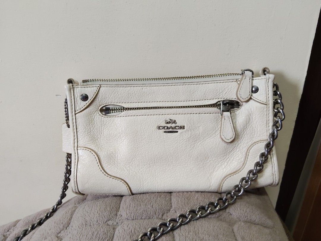 Coach White Leather Crossbody Bag with Chain Strap (Category: Cross-body Bags) located in Navotas City. Submitted by pereznahnah (Listing ID 1458758650, Image 1). Description: - Authentic Coach white leather crossbody bag - Textured leather finish - Silver-toned hardware - Stylish chain strap - Multiple zippered compartments for secure storage - Interior slip pockets for organization - Ideal for carrying daily essentials Made in the Philippines w