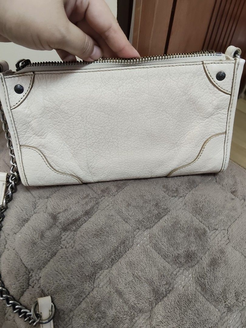 Coach White Leather Crossbody Bag with Chain Strap (Category: Cross-body Bags) located in Navotas City. Submitted by pereznahnah (Listing ID 1458758650, Image 2). Description: - Authentic Coach white leather crossbody bag - Textured leather finish - Silver-toned hardware - Stylish chain strap - Multiple zippered compartments for secure storage - Interior slip pockets for organization - Ideal for carrying daily essentials Made in the Philippines w